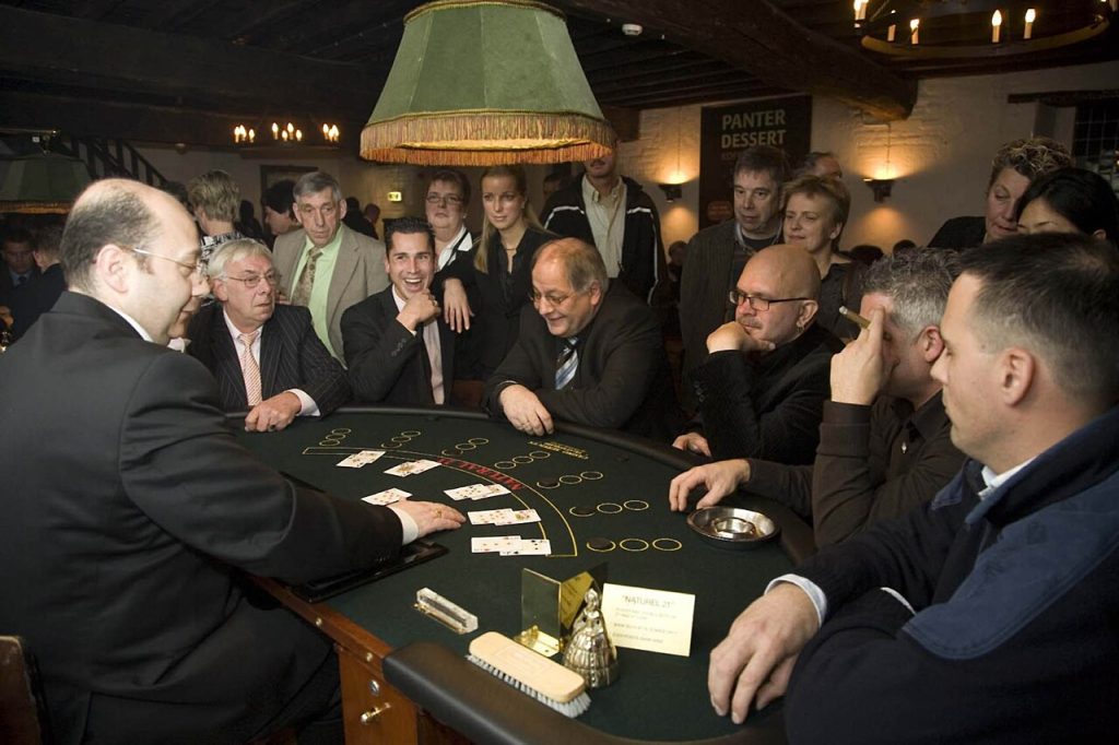 Players at a live casino card table